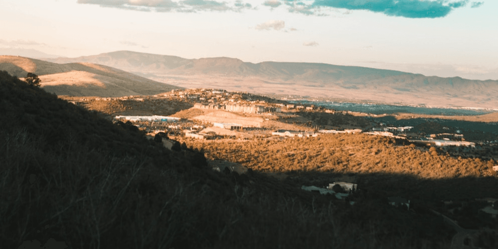 Hills at sunset overlooking buildings