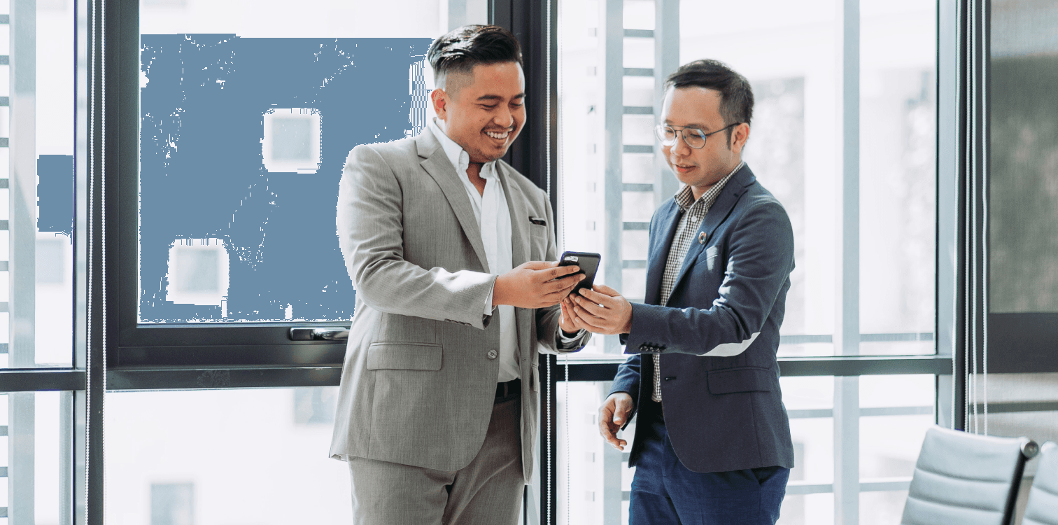 two men looking at cell phone