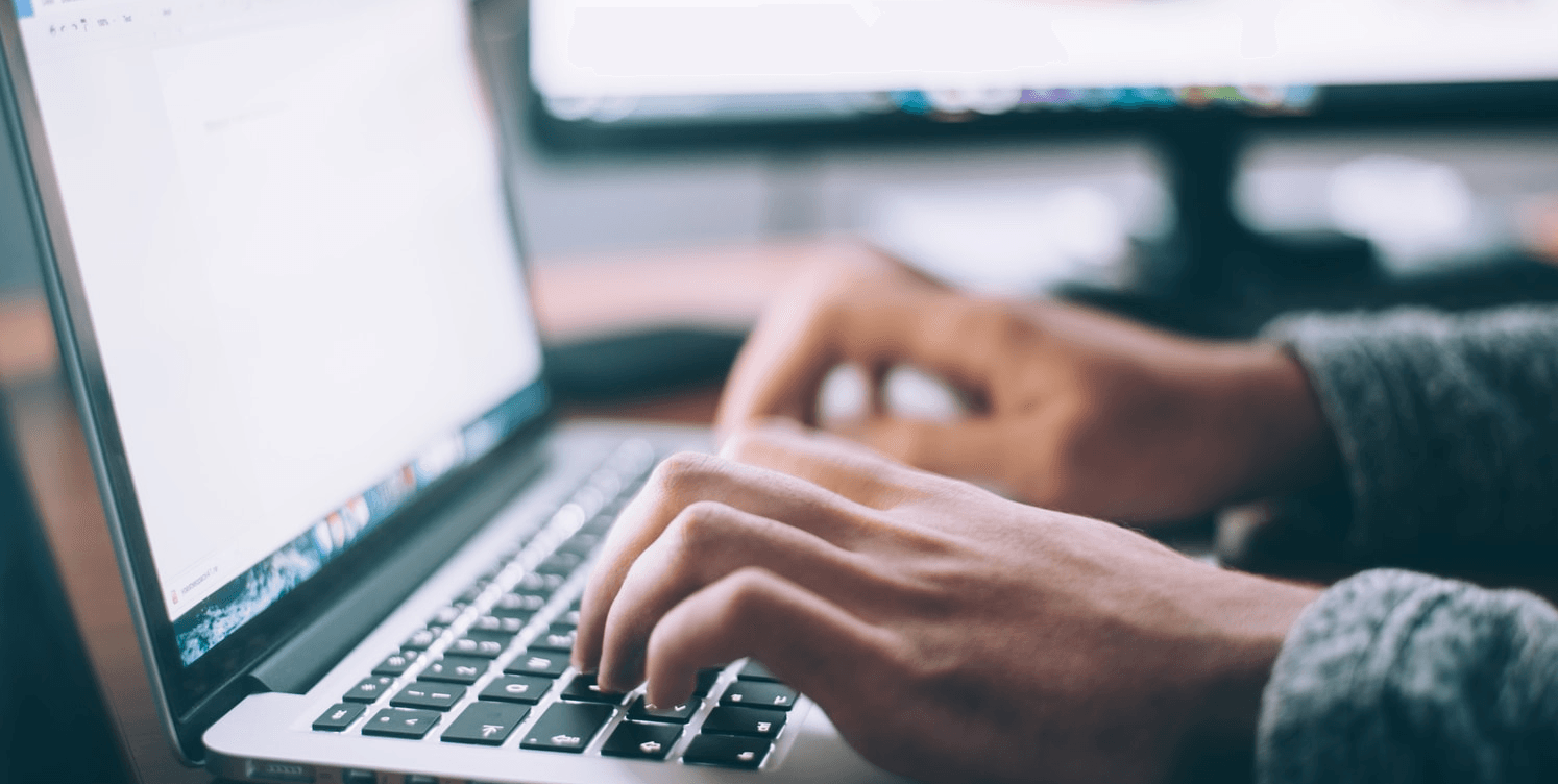 hands on laptop keyboard