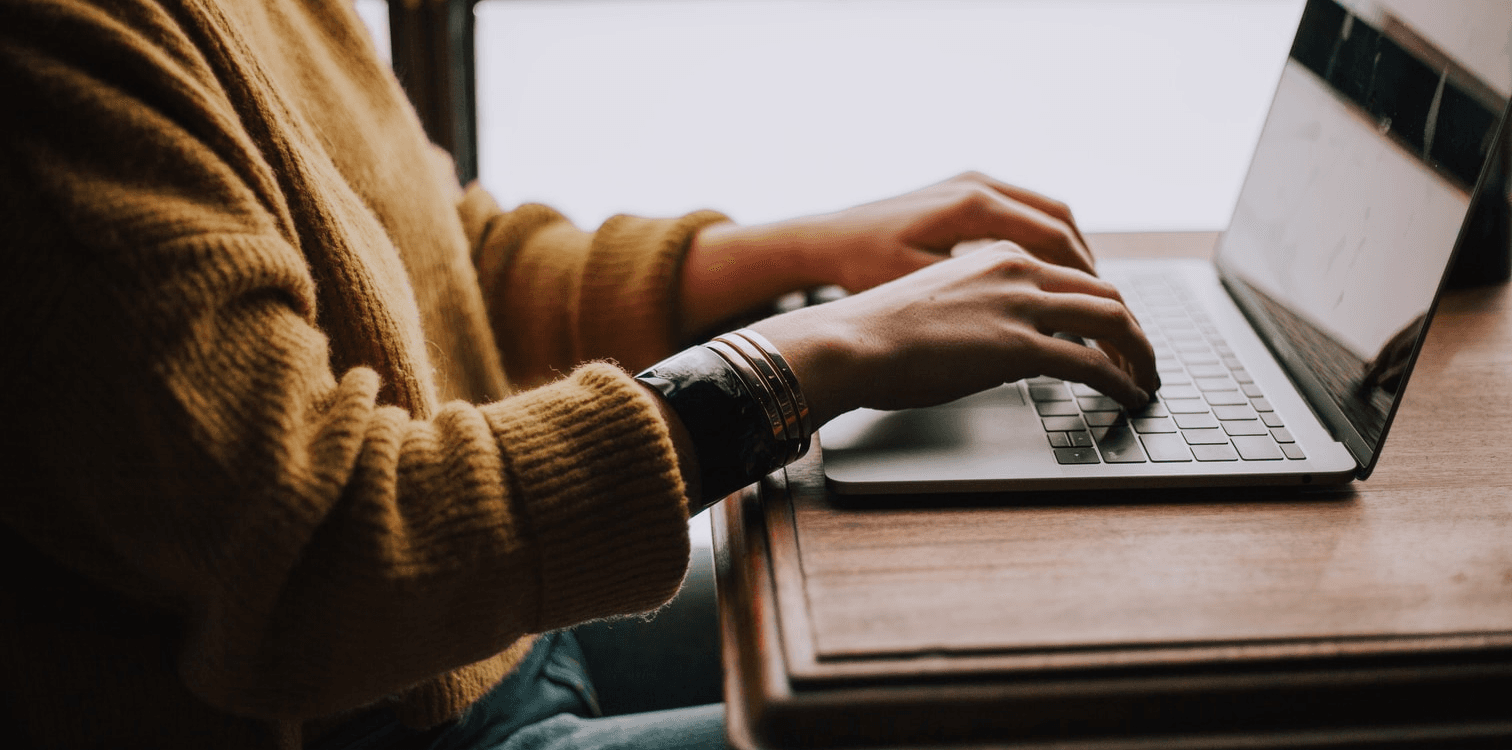 hands typing on laptop