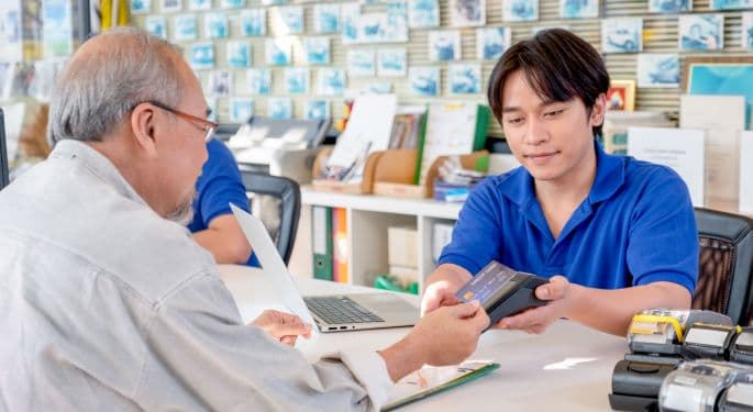 A salesperson checking out a customer in a shop. 