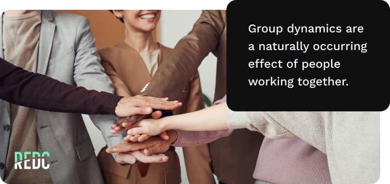 An all-hands in group exercise, with smiling coworkers.