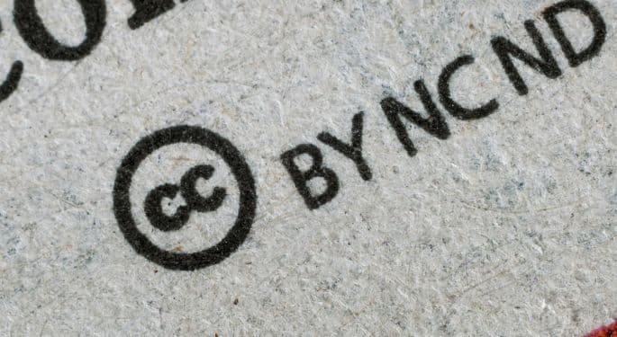 A copyright mark in black ink followed by "BY NCND" on paper