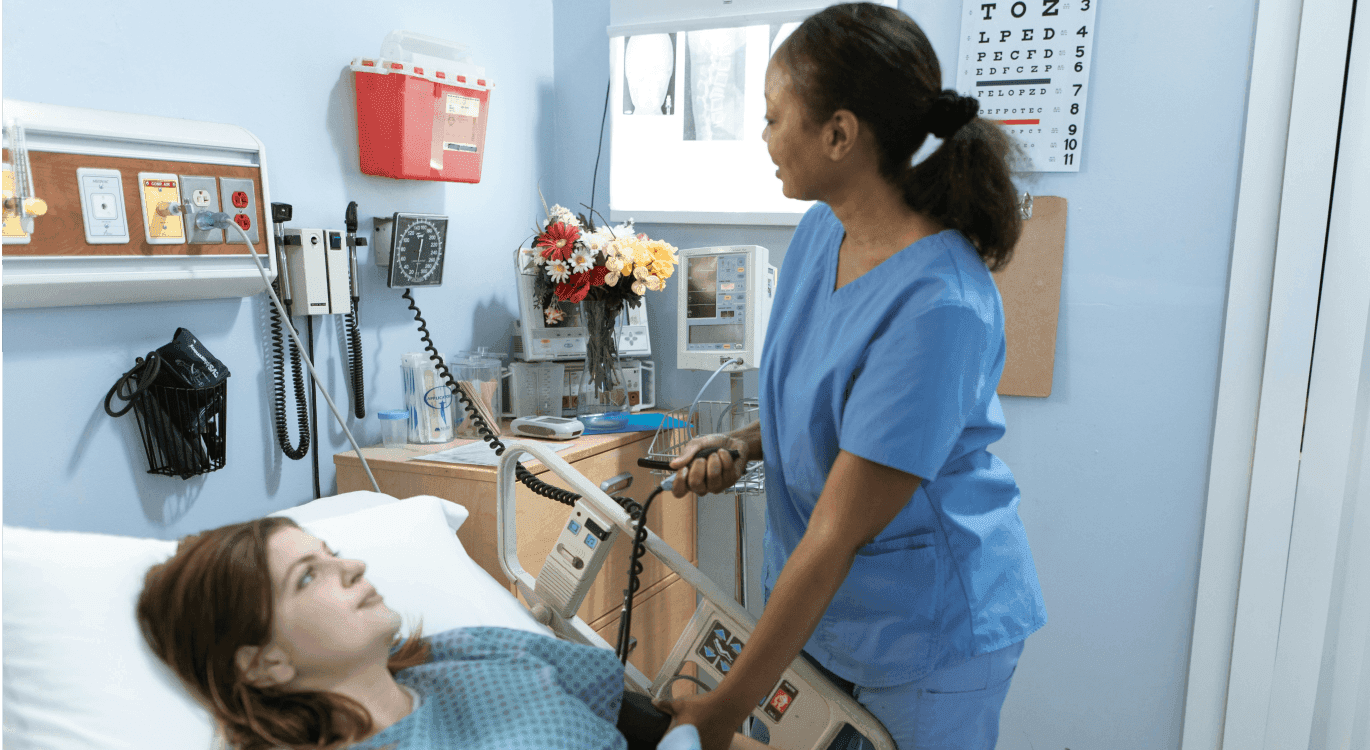 Image: a nurse in a hospital room checking a patient's blood pressure.
