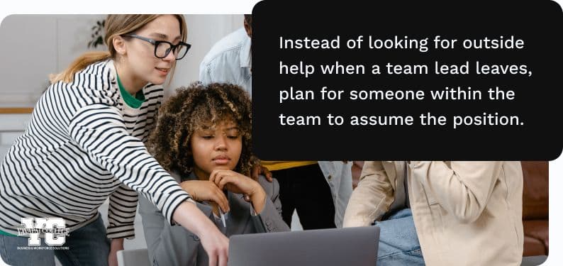 A group of coworkers looking at an office computer together.