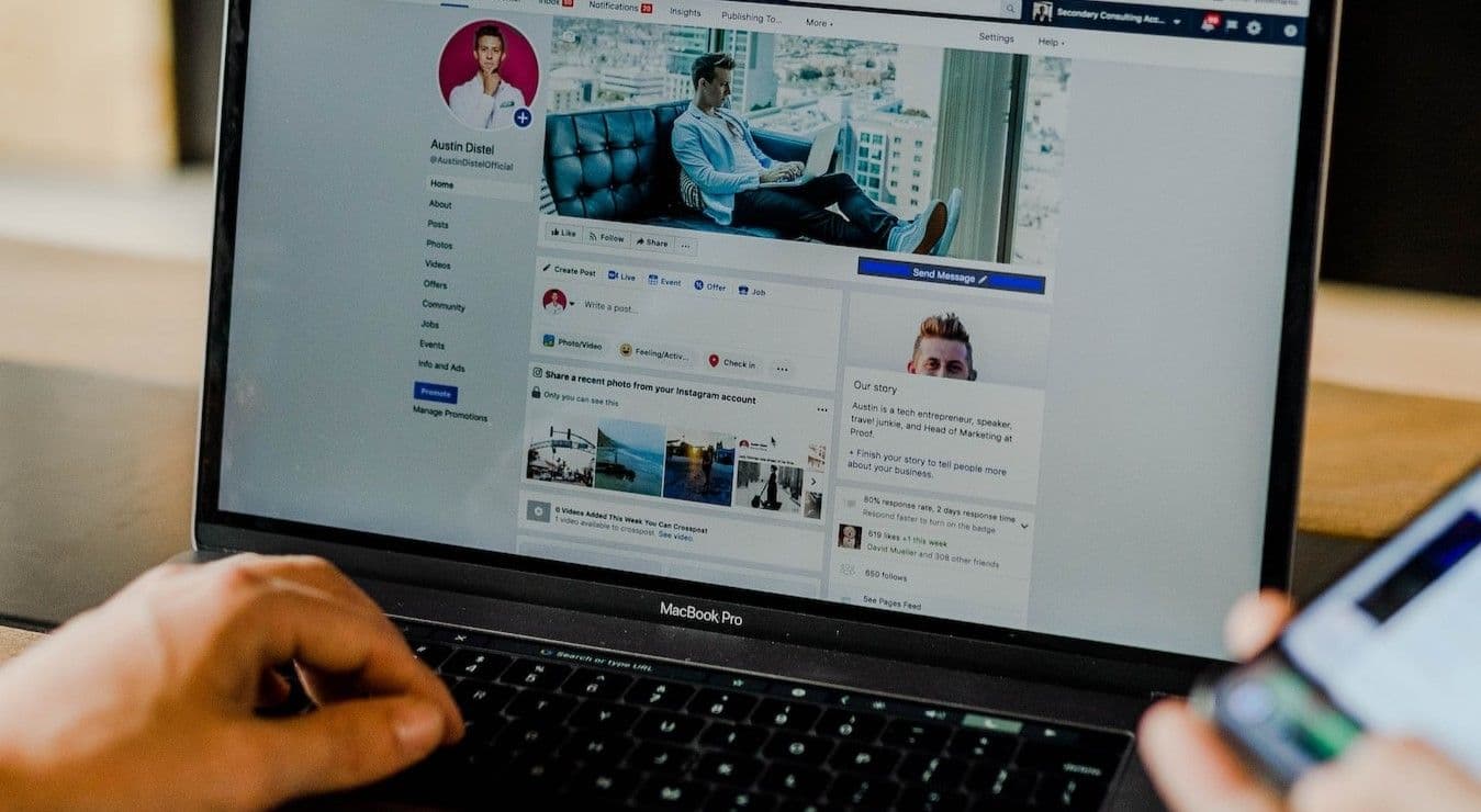 Person using computer and phone to look at social media