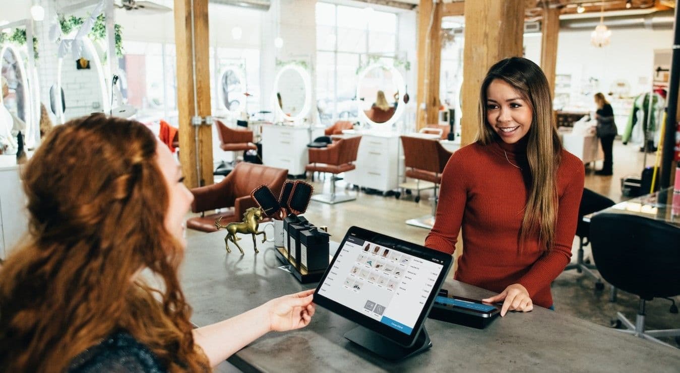 Cashier speaking to client
