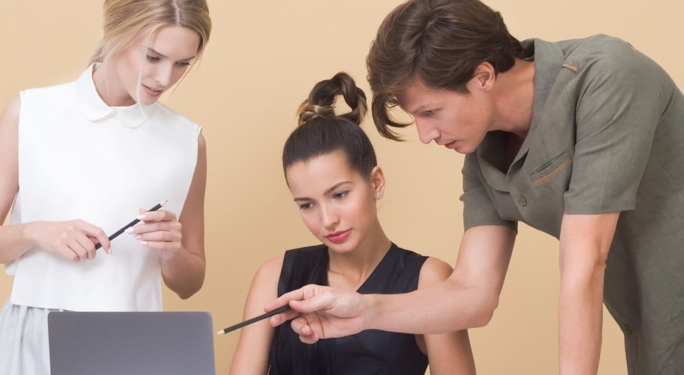 Young employees being trained by another young employee