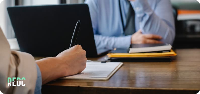 Soft skills for leaders: note taking at an office desk. 