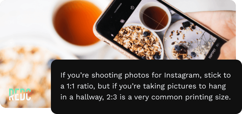 A smartphone taking a photo of a breakfast table.