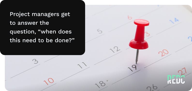 A thumb tack marking a date on a calendar. 